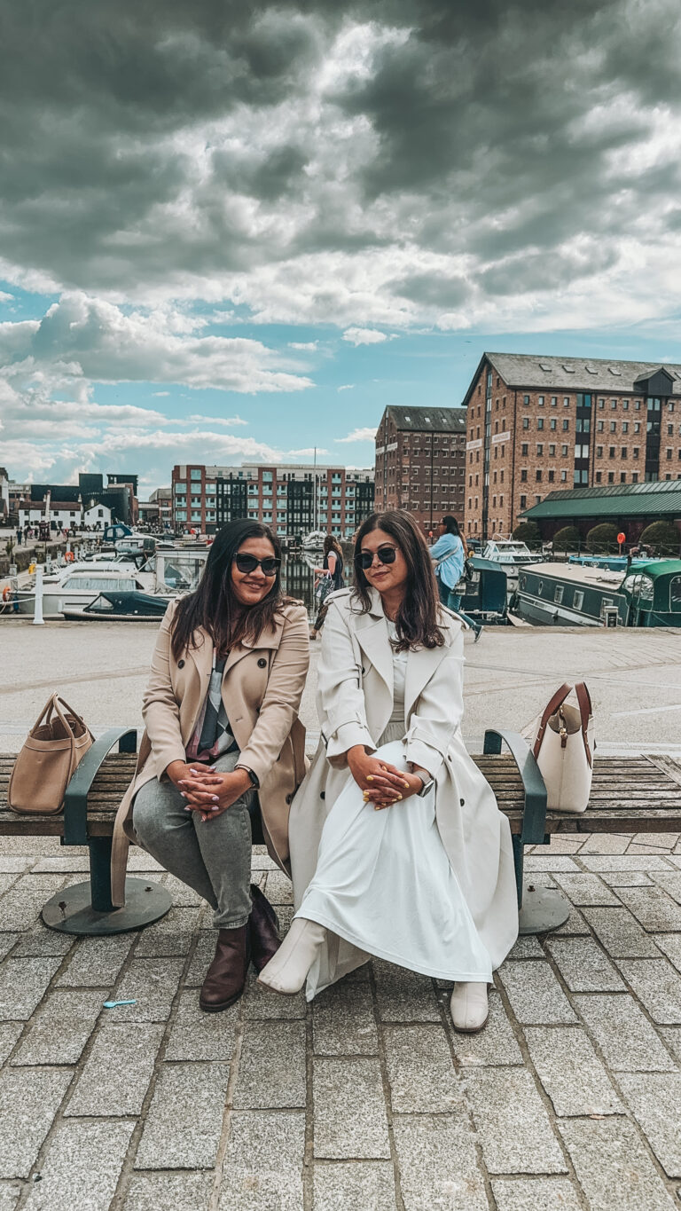 Two friends sitting on a bench chatting