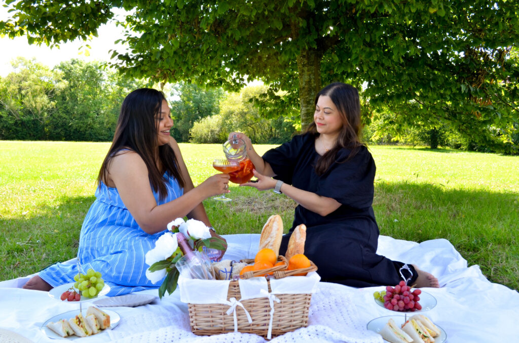 Two girl friends having a picnic in a park