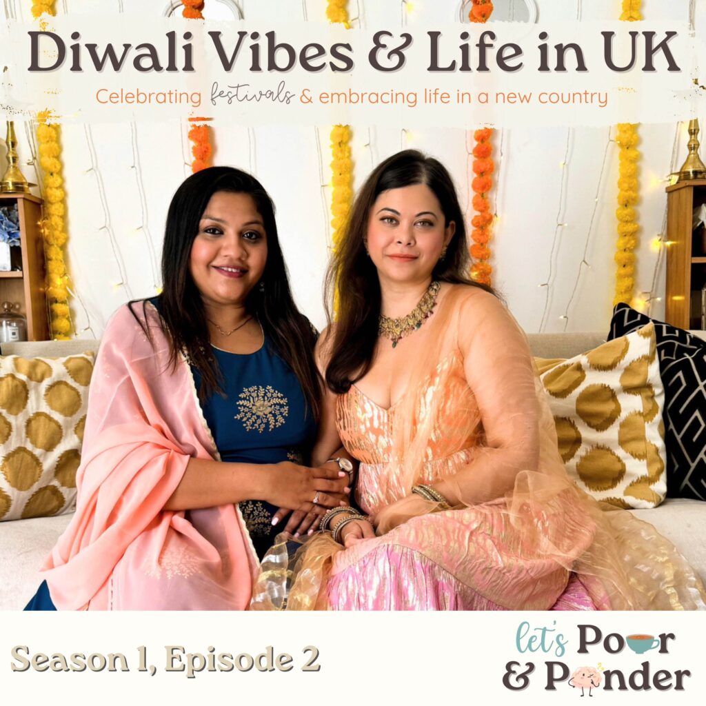 Pooja and Nikita hosts of Let's Pour and Ponder podcast dressed up in diwali outfits and sitting on a couch smiling at the camera!